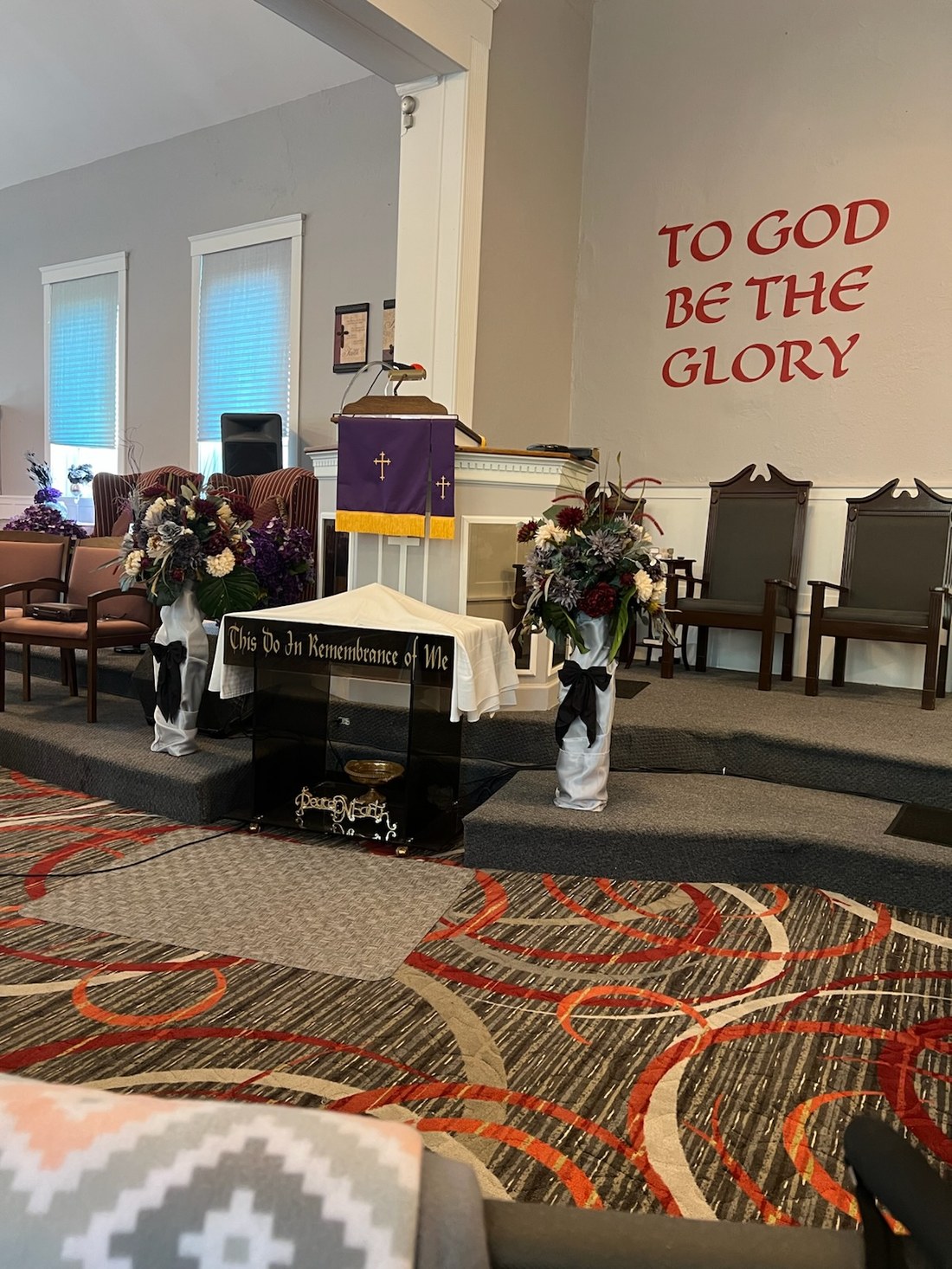 The altar and pulpit at Greater Mt. Olivet, with "To God Be The Glory" on the wall